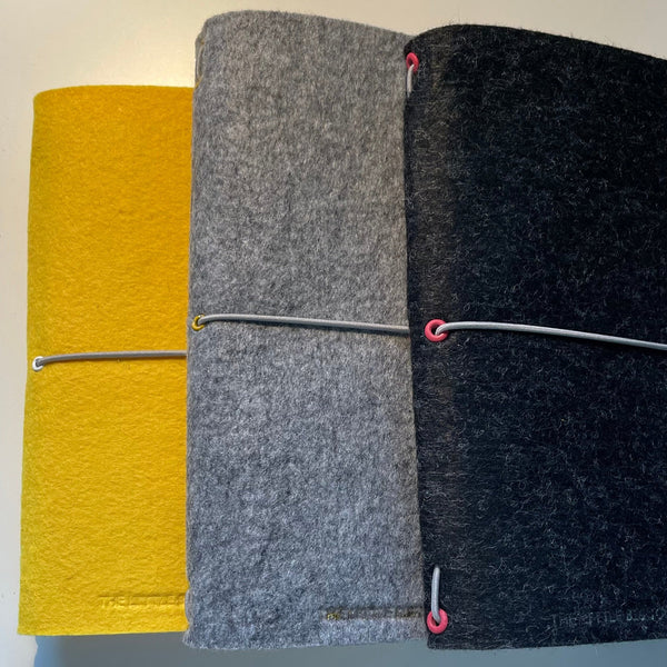 A5 felt journal wrap yellow, light grey and charcoal grey fanned to show range
