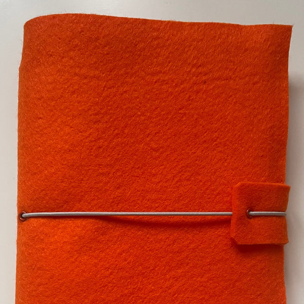 Bright orange felt wrap with elastic strap to hold the contents secure