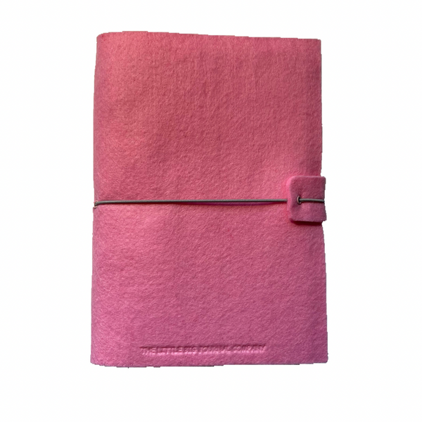 Pink felt wrap A5 refillable journal with elastic strap holding notebooks inside