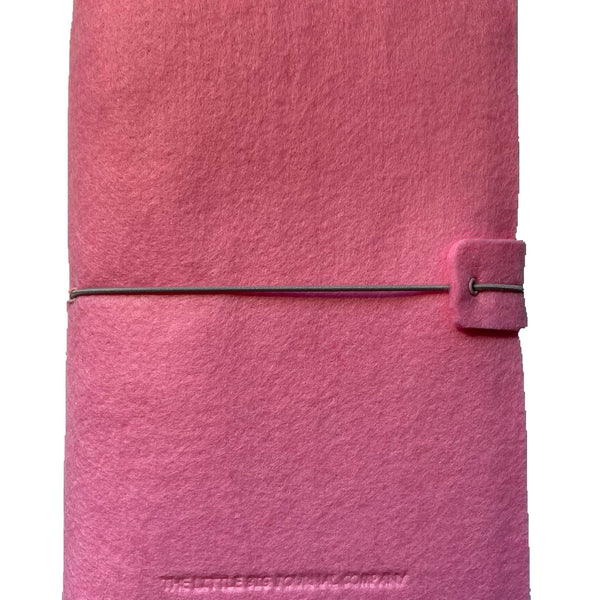 Pink felt wrap A5 refillable journal with elastic strap holding notebooks inside
