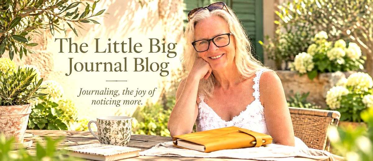 A smiling woman with glasses sits at an outdoor table with a journal, mug, and flowers in a garden setting. Large text on the left reads 'The Little Big Journal Blog' with the subtitle 'Journaling, the joy of noticing more.