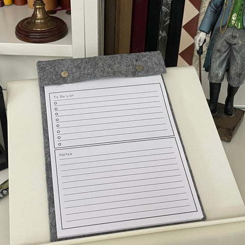 Grey Felt desk notepad with tear off pages, refillable shown on study desk